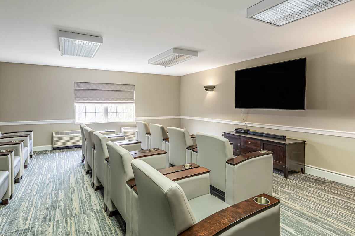 Interior lounge area with seating and large screen