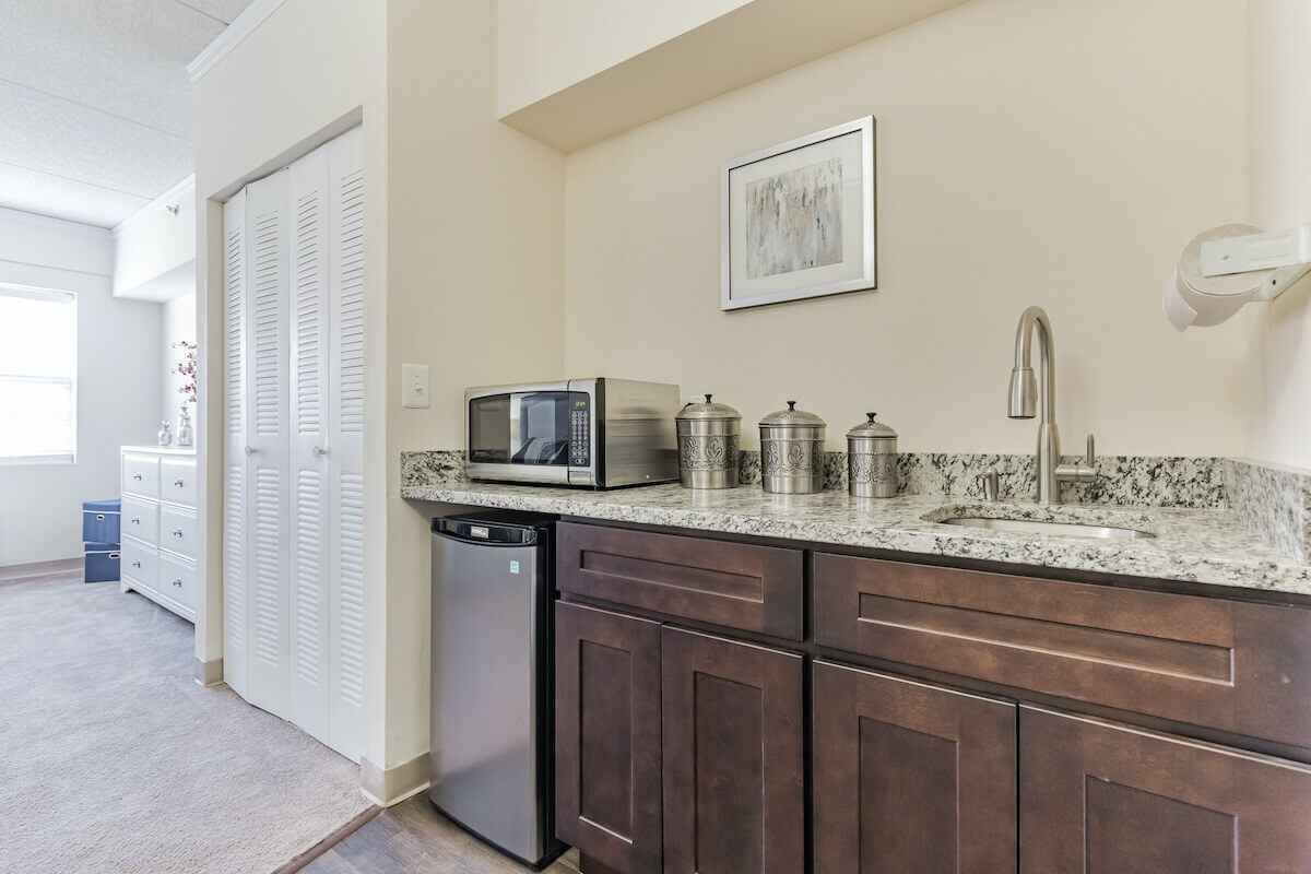 Interior kitchenette area with microwave and fridge