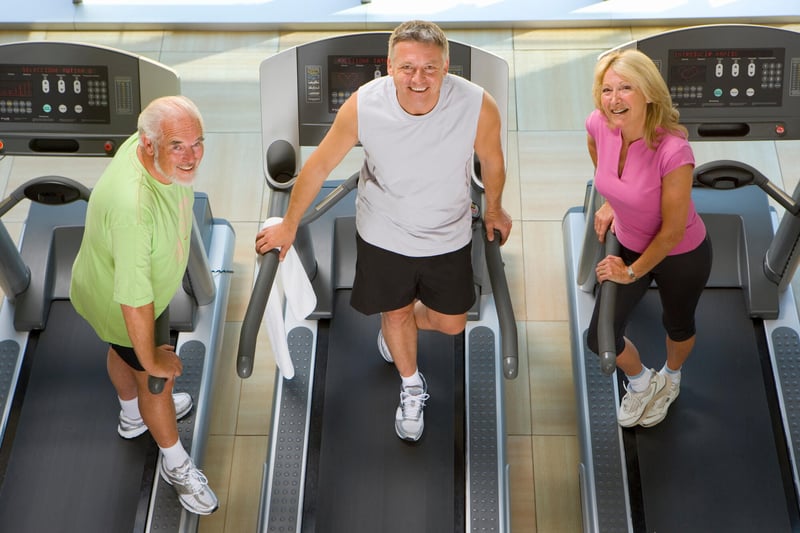 Residents exercising on treadmills in a fitness area