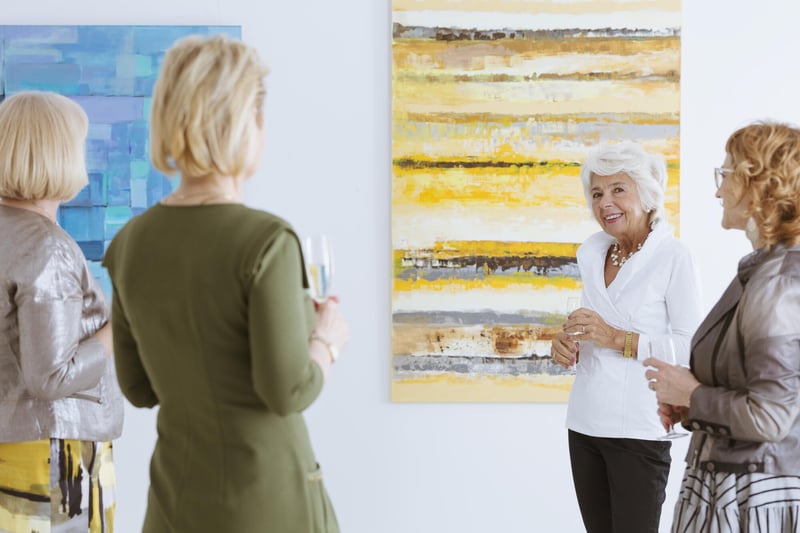 Residents enjoying an art viewing in a gallery.