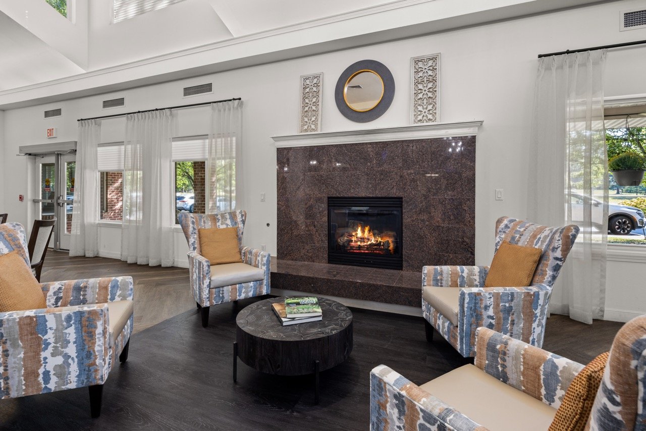 Bright common area with seating and a fireplace