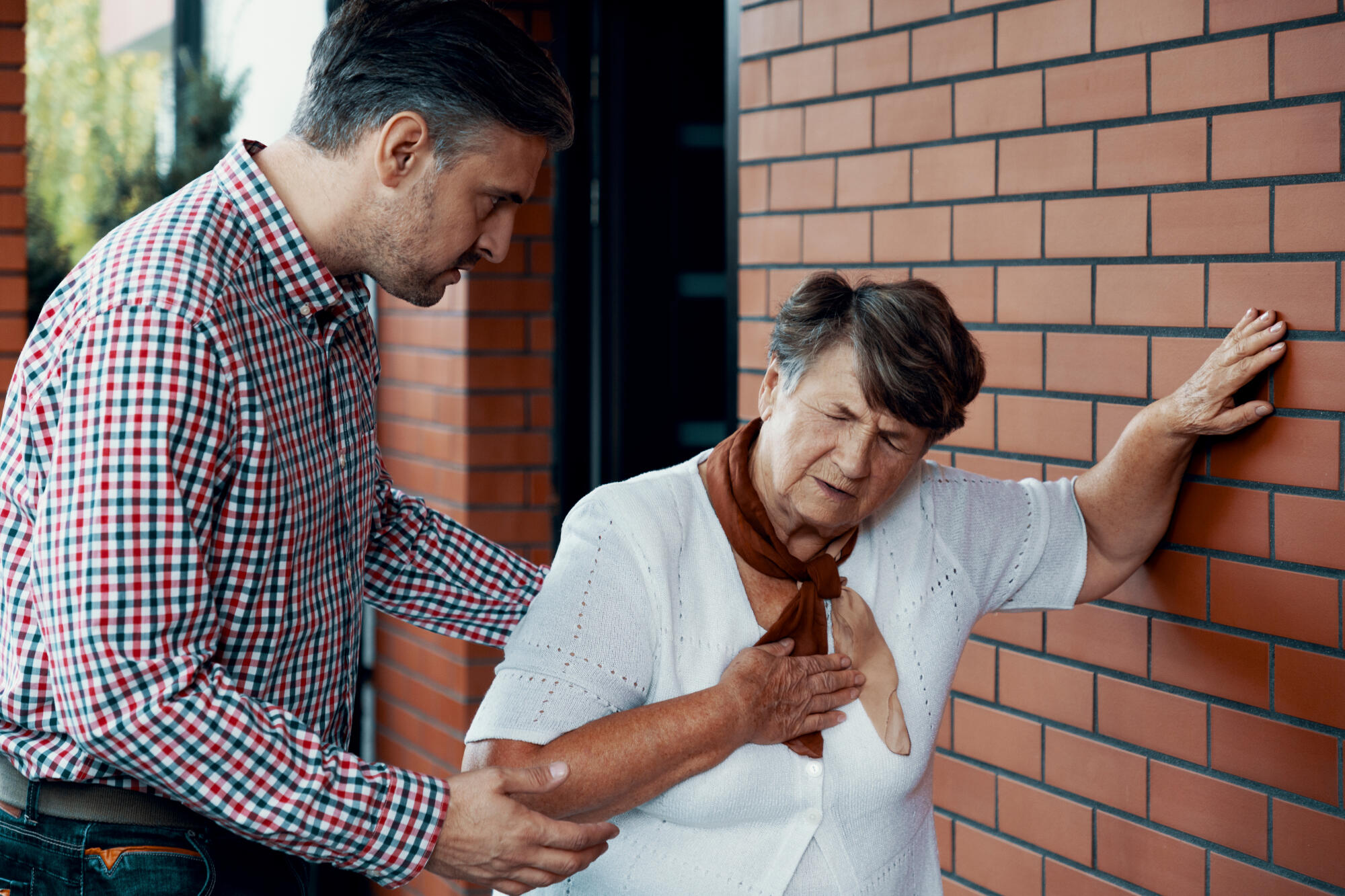 Caregiver assisting a resident outdoors
