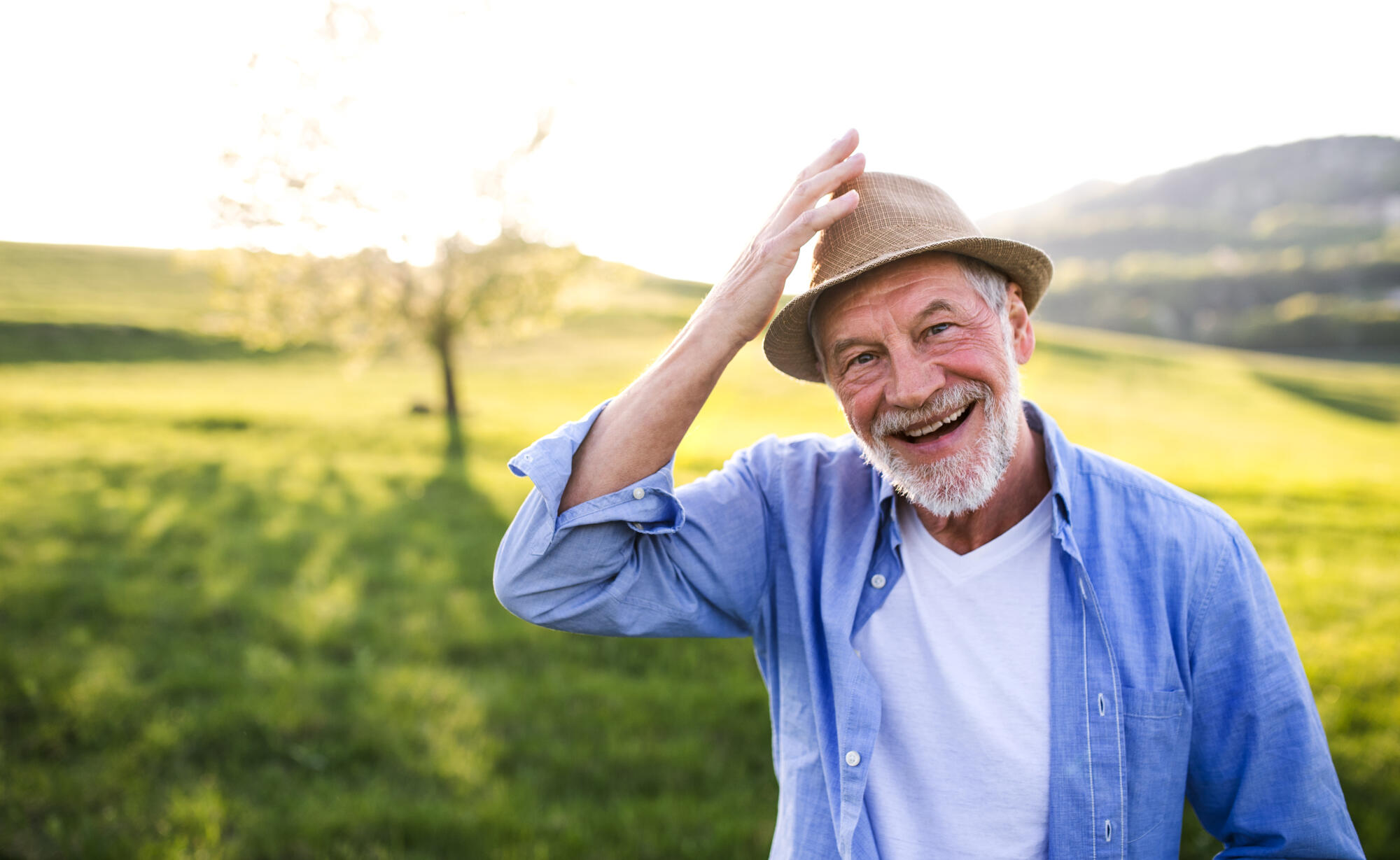 Smiling senior man outdoors in a field