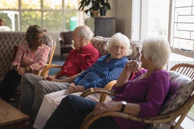 Residents engaged in conversation in a cozy common area