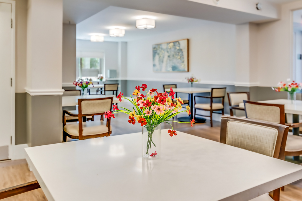Bright common area with flower arrangements and seating