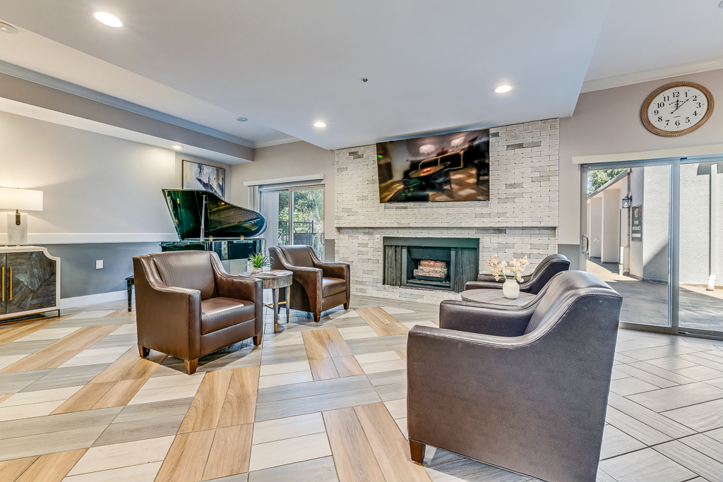 Comfortable common area with a fireplace and piano