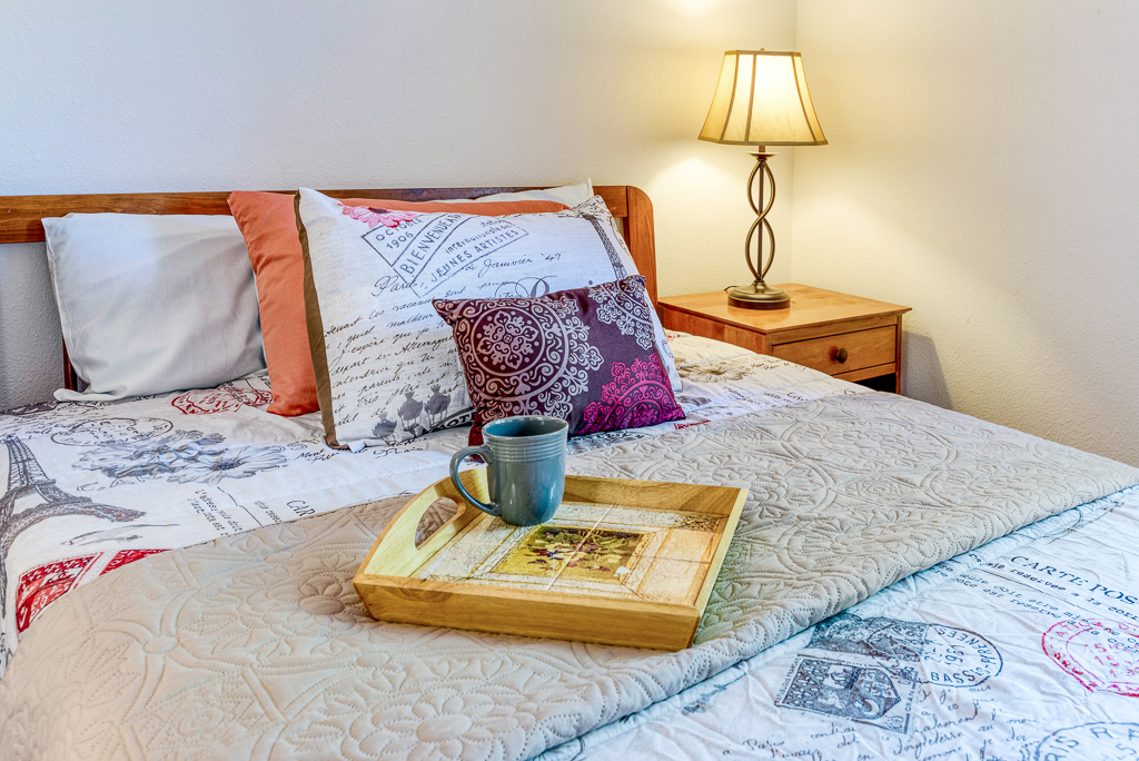 A cozy resident room with a bed and lamp