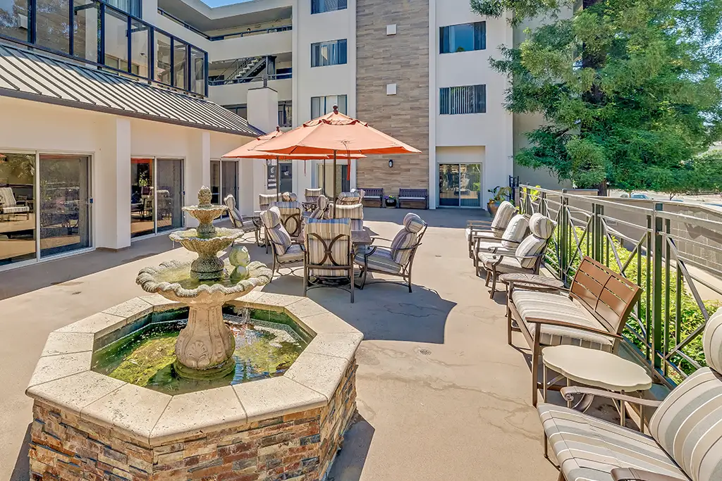 Outdoor seating area with a fountain and umbrellas