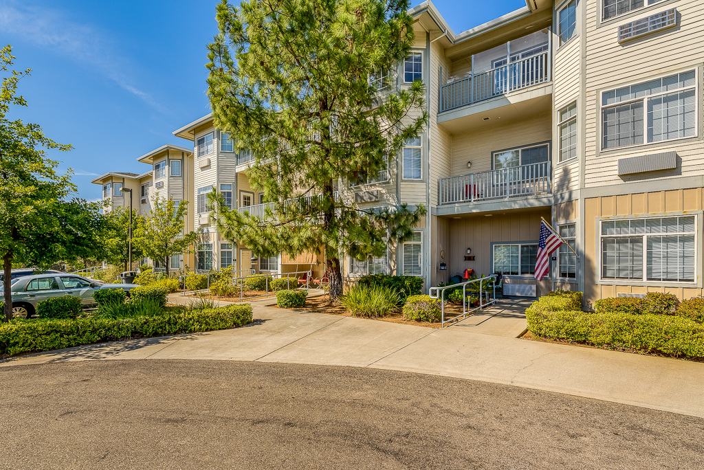 Exterior view of a senior living facility with landscaped entrance