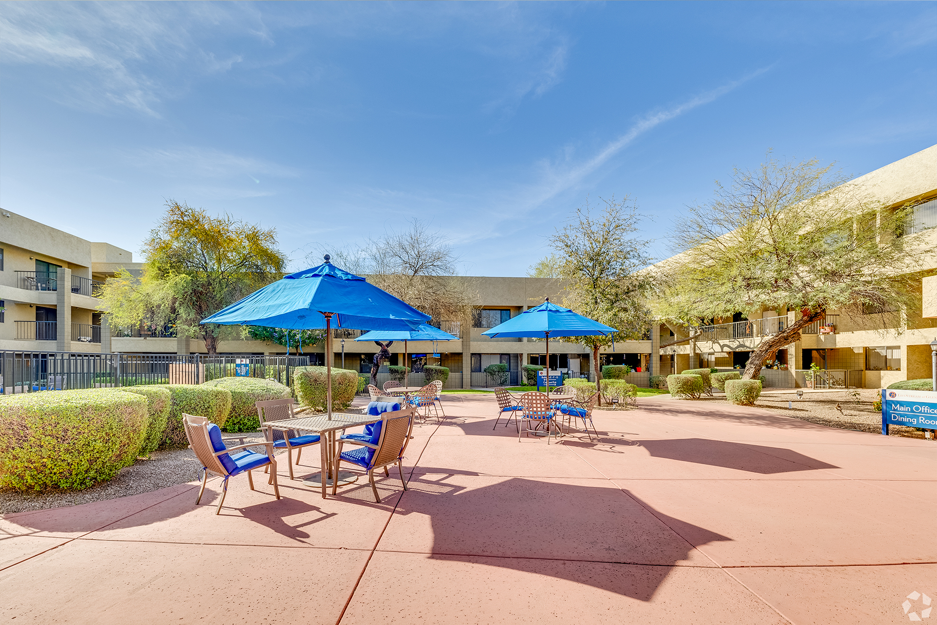 Outdoor seating area with umbrellas and landscaping