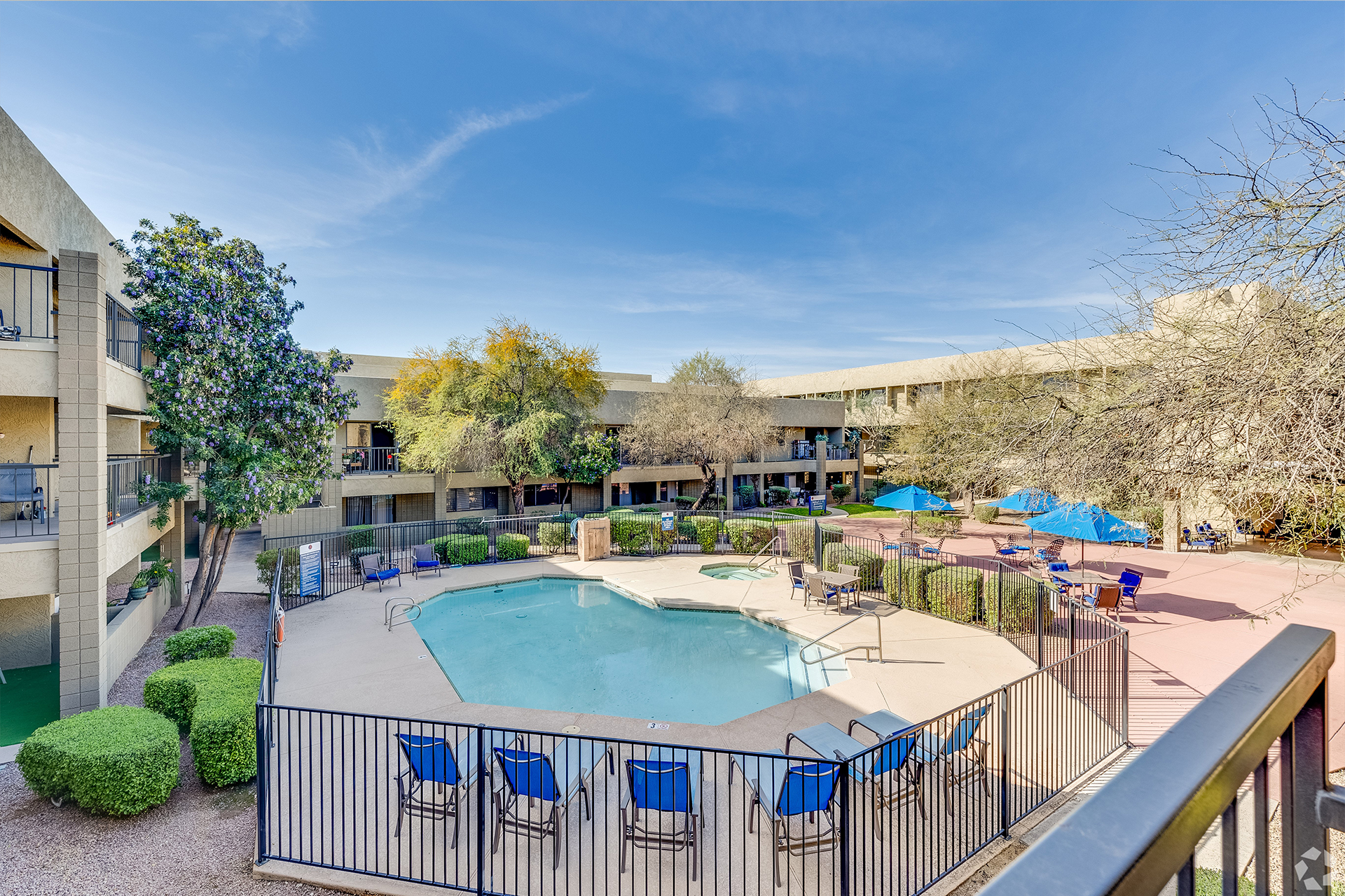 Outdoor courtyard with a swimming pool and seating areas