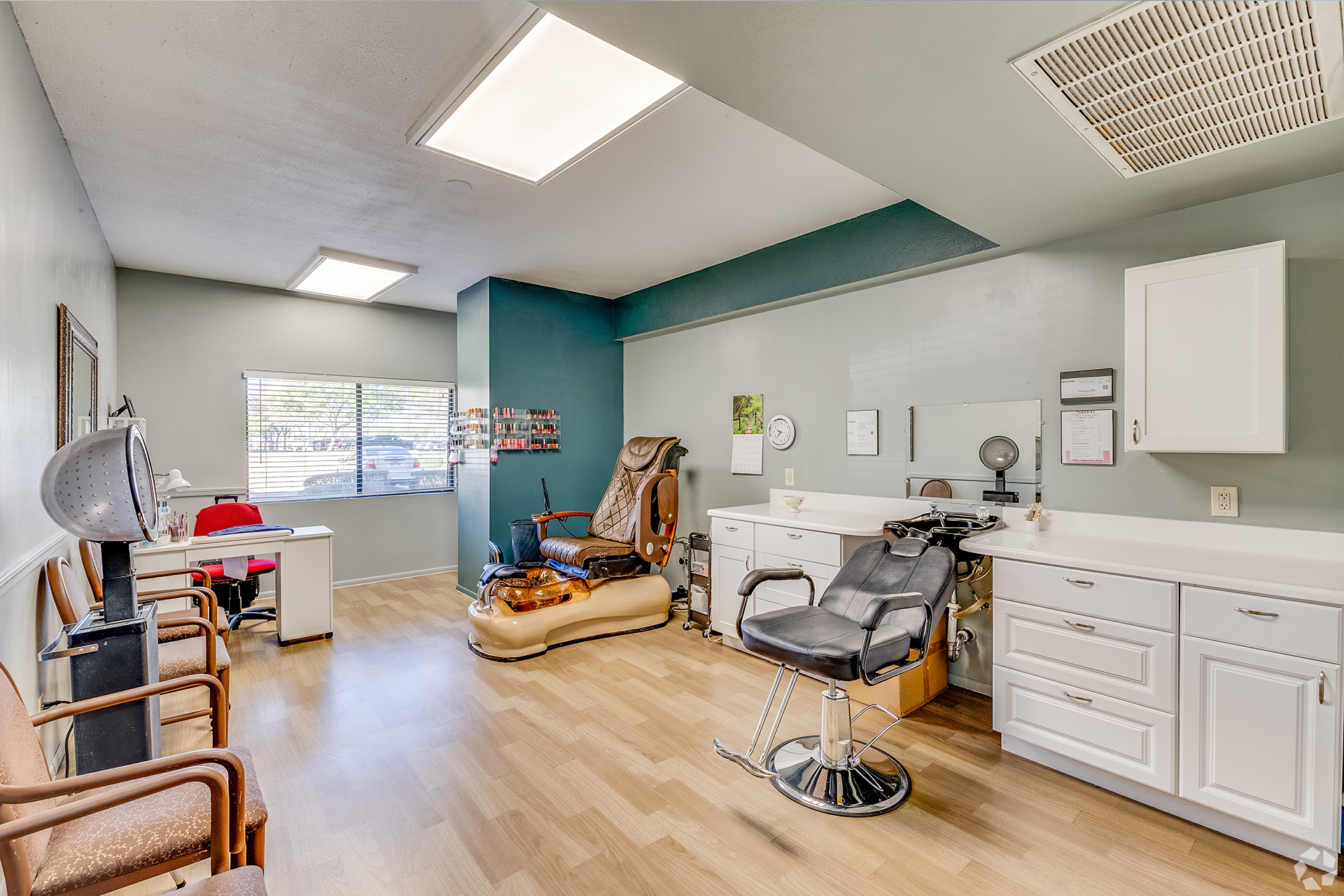 Well-lit hair salon space with chairs and equipment