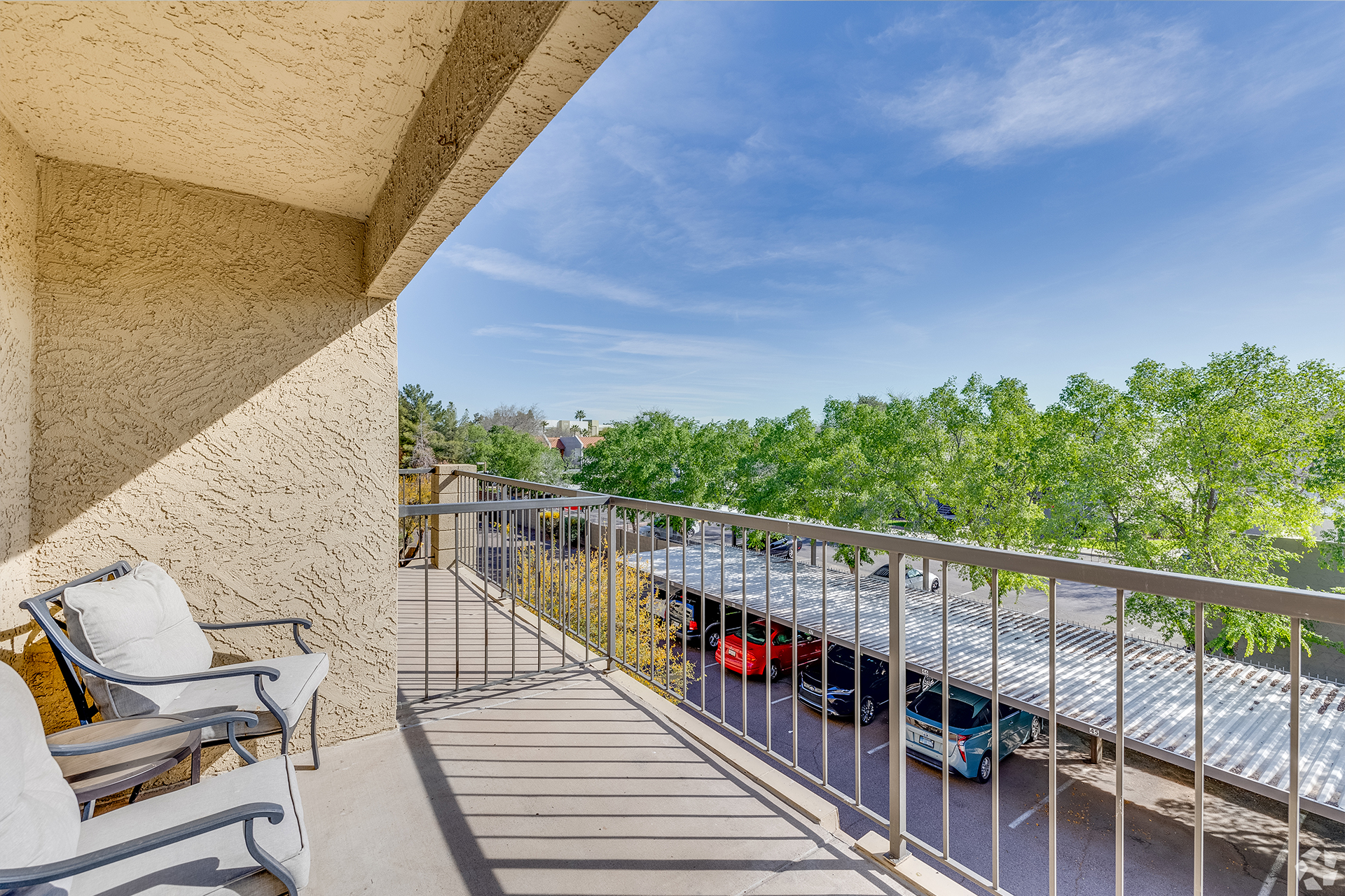 View from a balcony overlooking a parking area