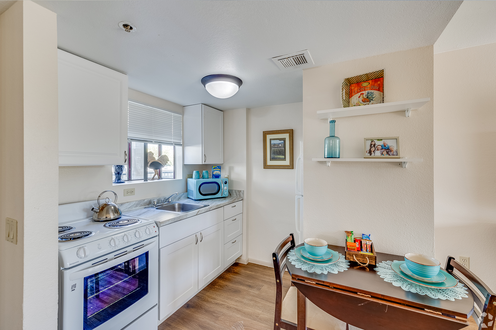 A well-lit kitchen area with dining table and decor