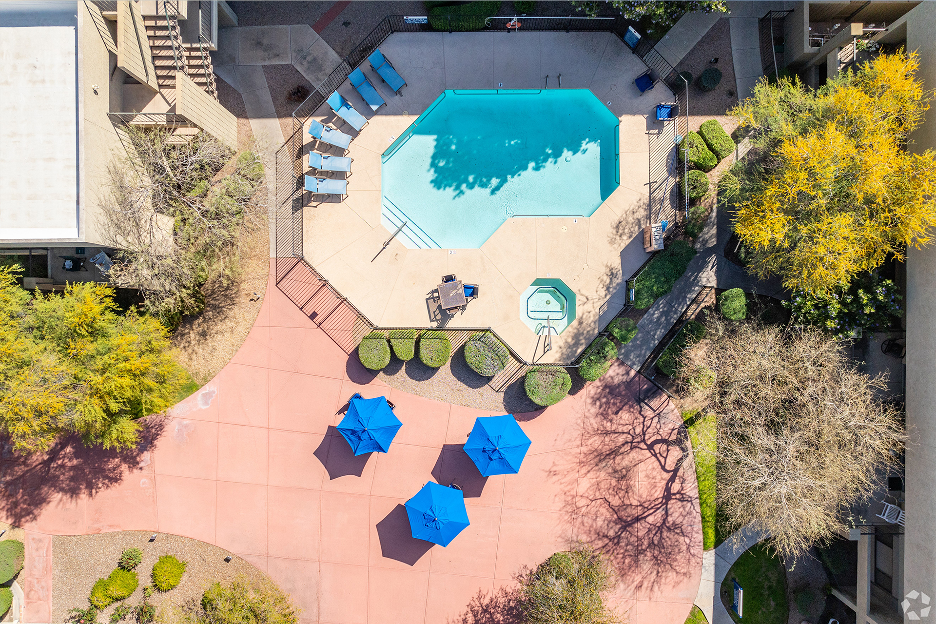 Aerial view of a swimming pool area with sun loungers