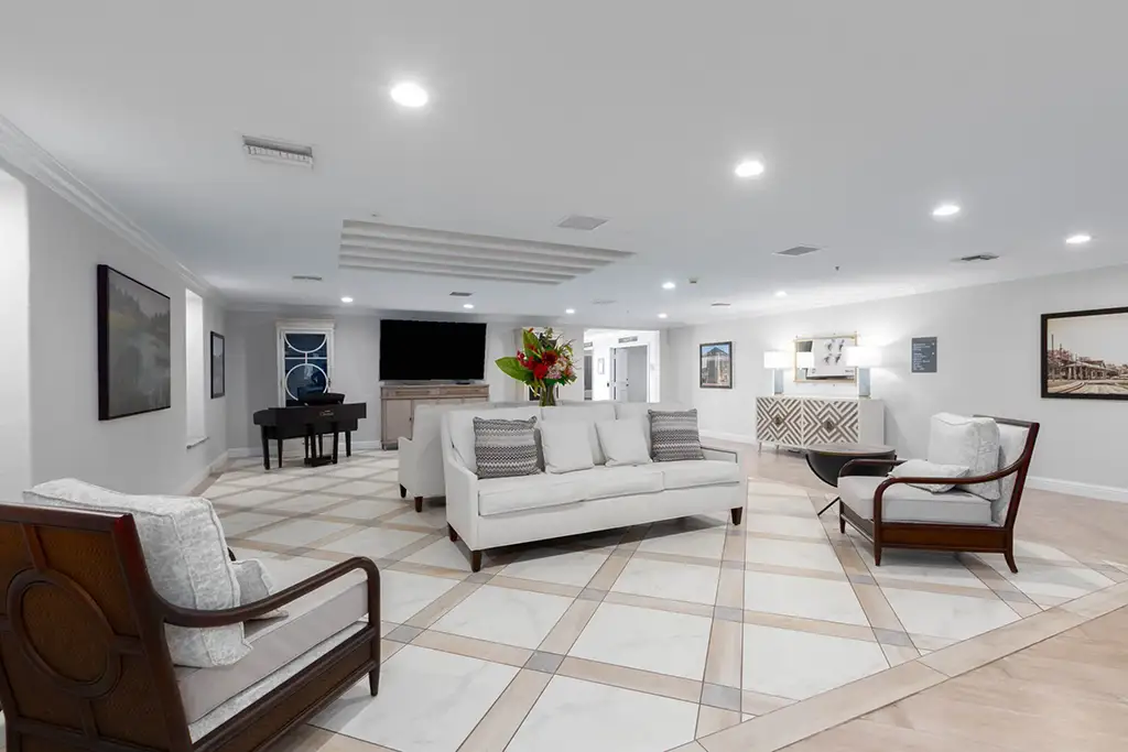 Bright common area with seating and piano