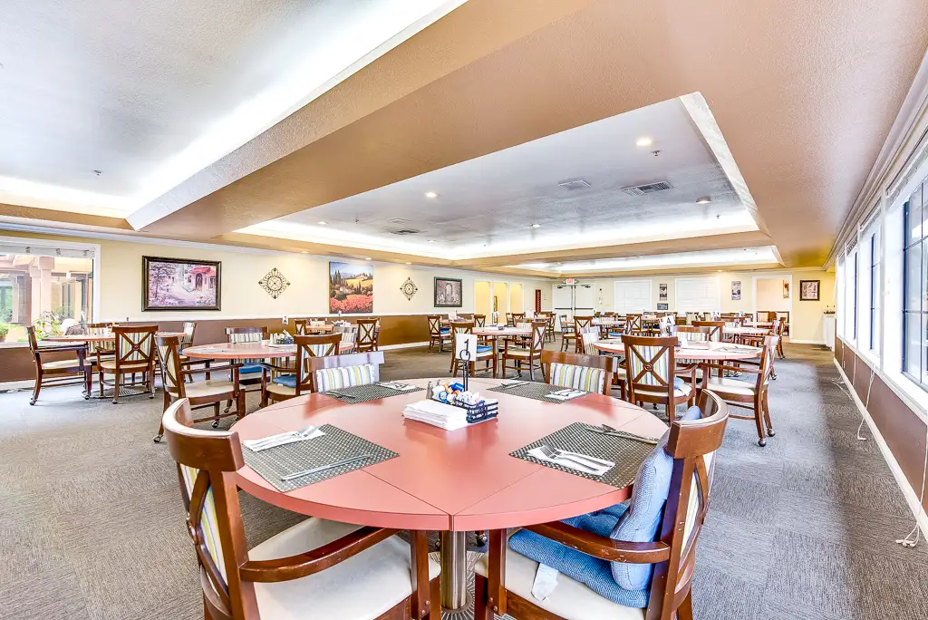 Bright dining room with tables set for residents