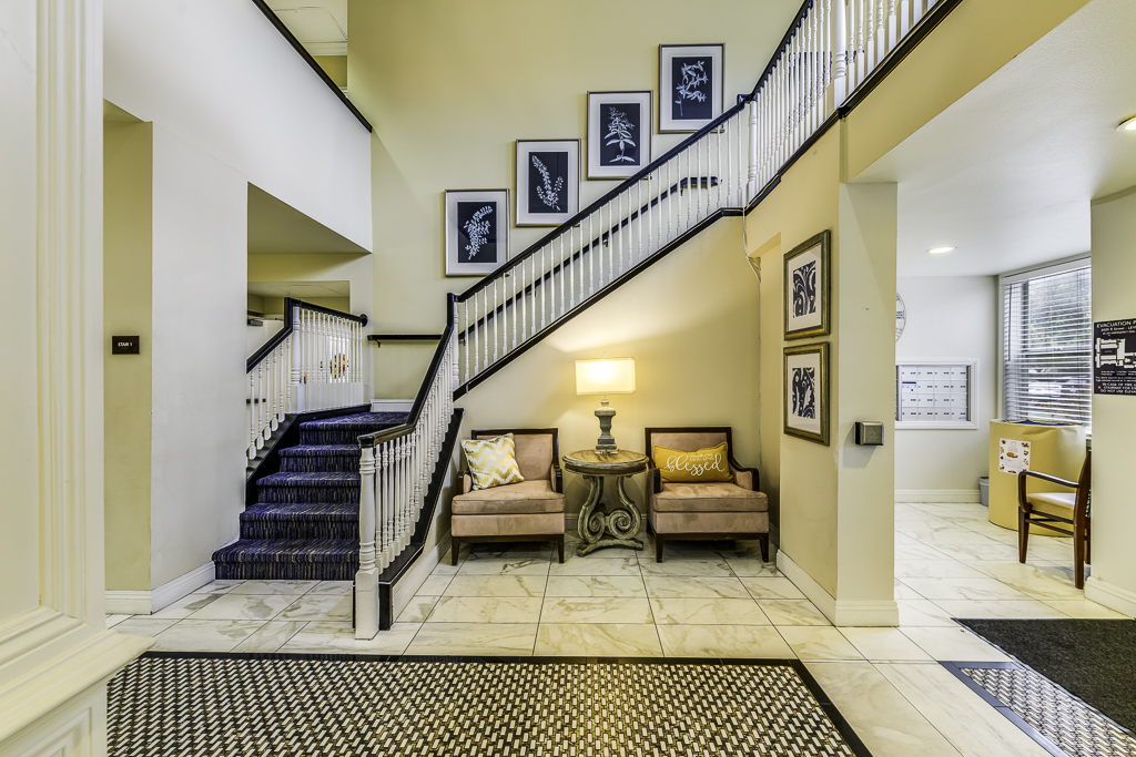 Bright lobby area with staircase and seating