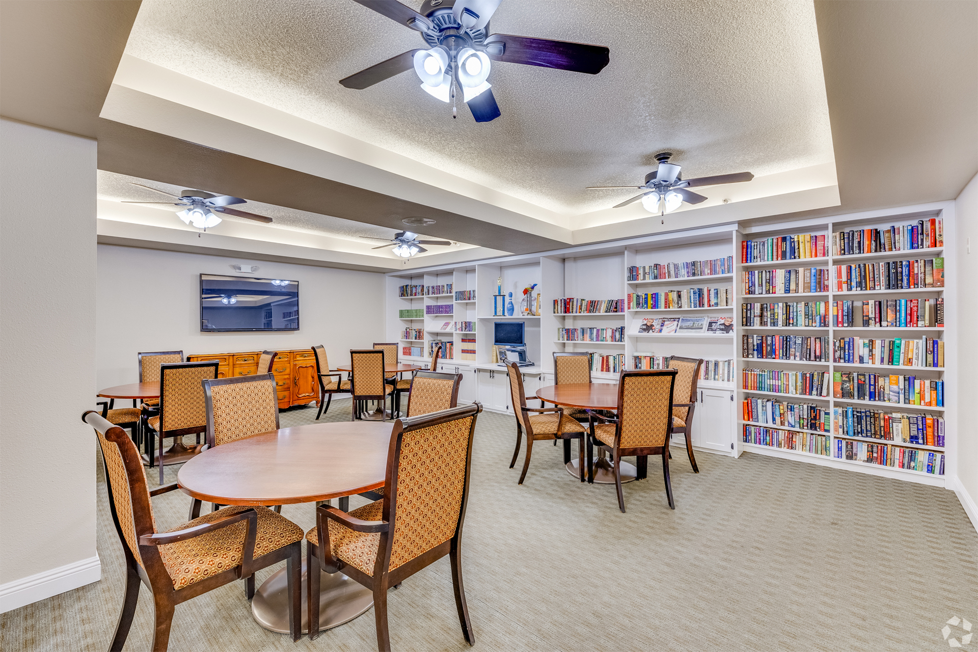 Bright common area with bookshelves and seating