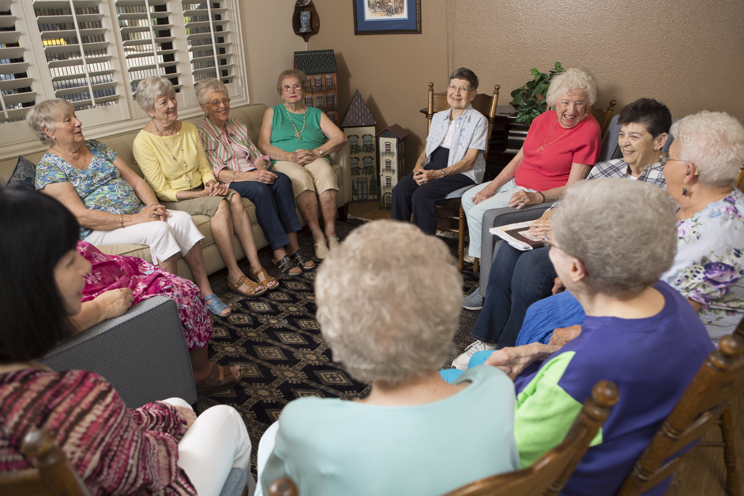 Group of women engaged in conversation in a common area