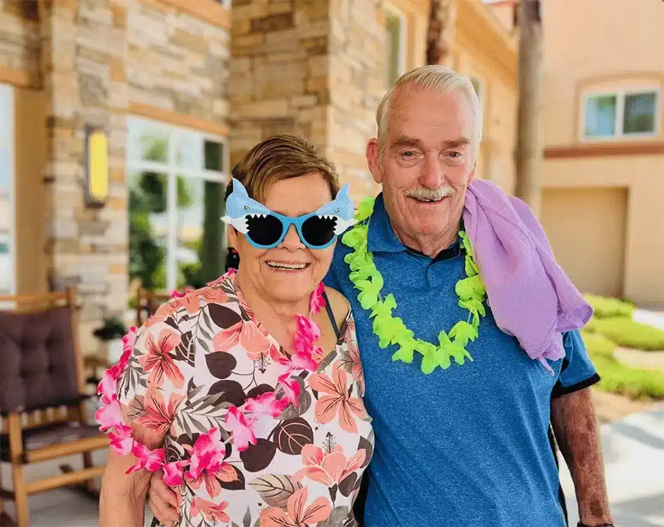 Residents enjoying a themed outdoor event with leis