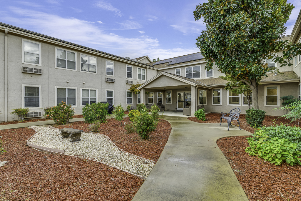 Garden area with pathways and seating in a senior living facility