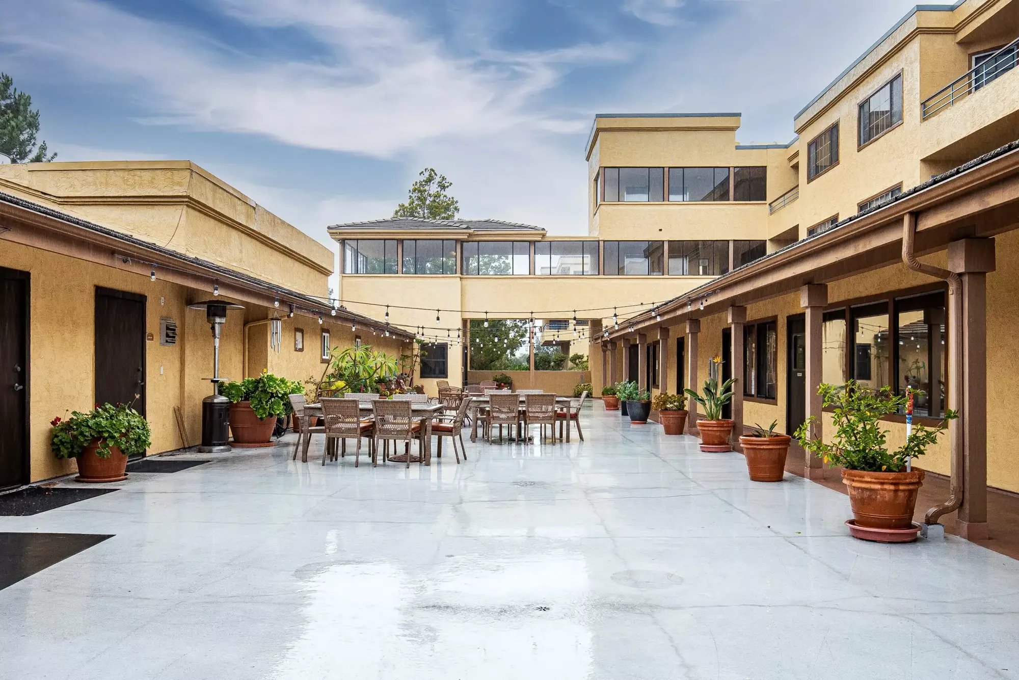 Outdoor courtyard area with seating and potted plants