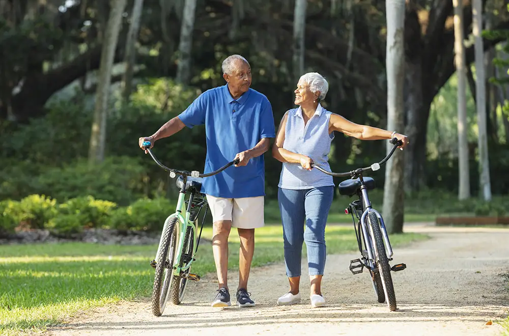 Elderly couple enjoying a bike ride in a park