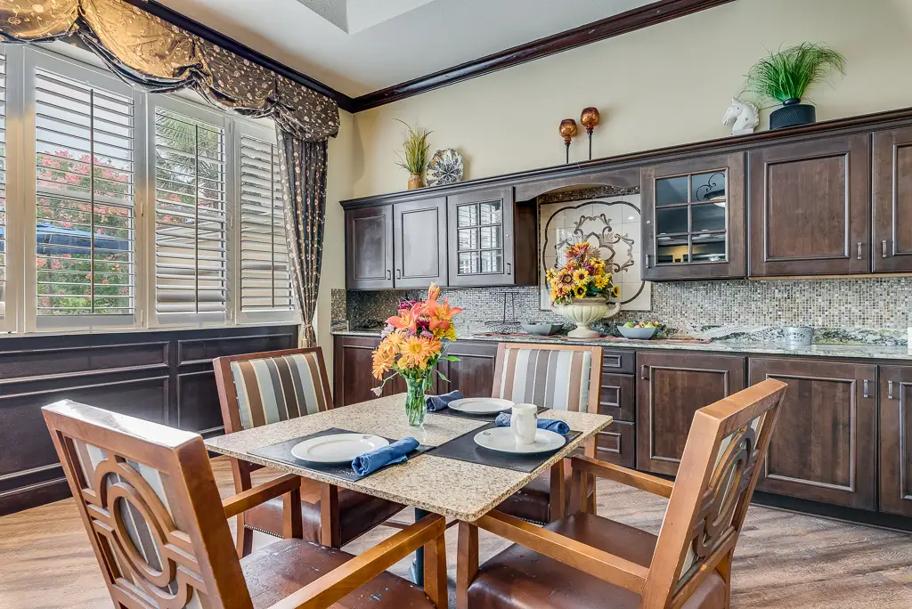Dining area with flowers and table setting