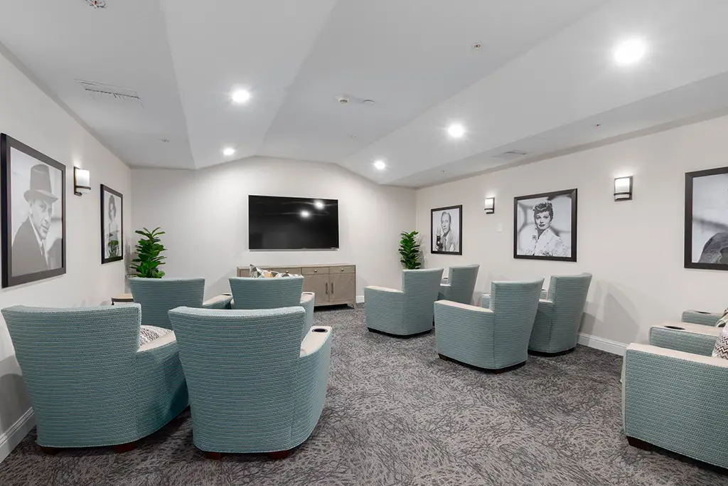 Common area with chairs and wall portraits