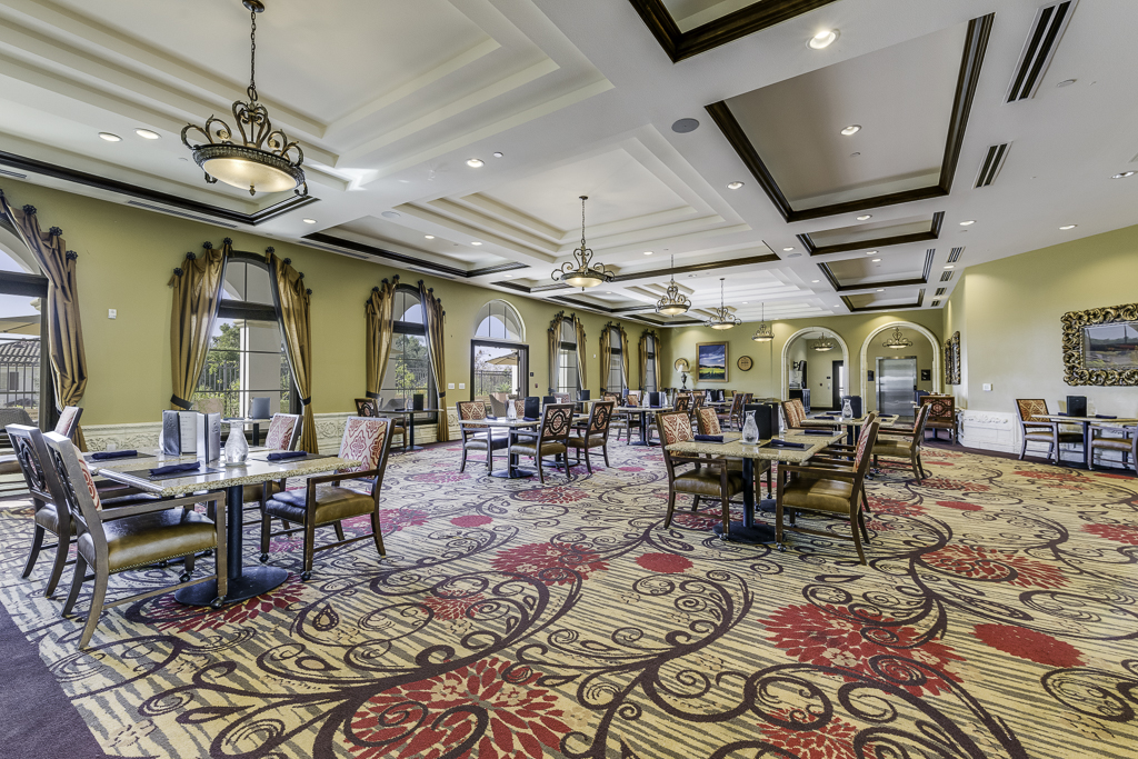 Elegant dining room with large windows and decorative chairs