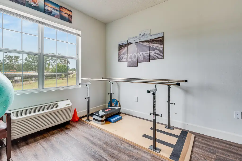 Physical therapy space with parallel bars and equipment