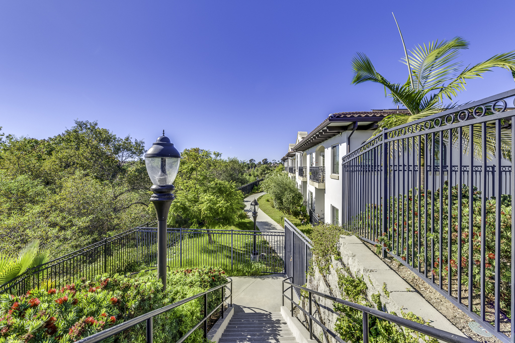 Outdoor pathway lined with greenery and flowers