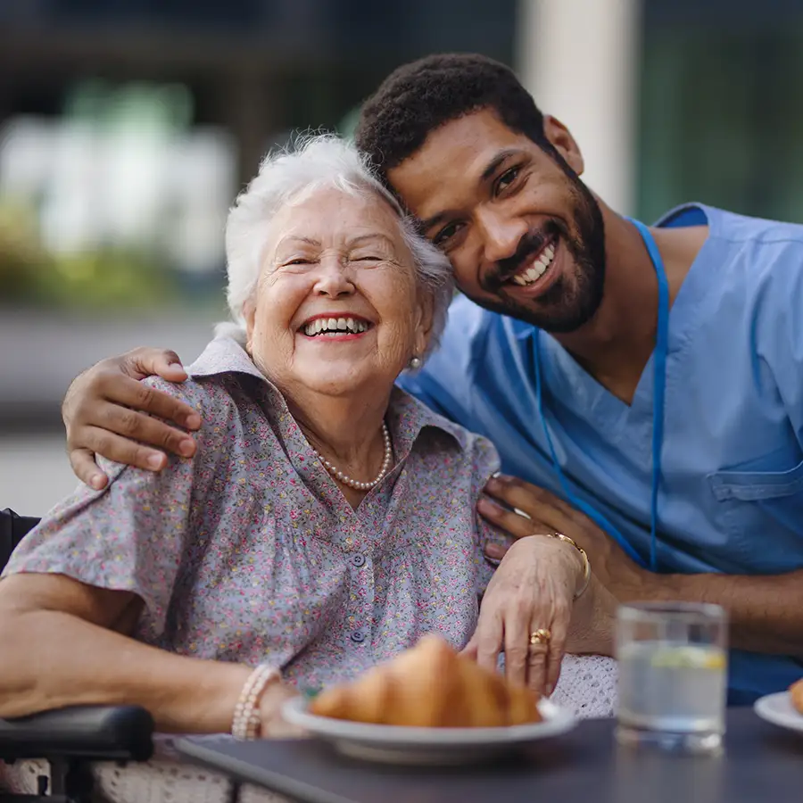 Caregiver with a resident enjoying a meal together