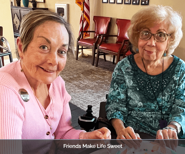Two residents smiling while engaging in an activity