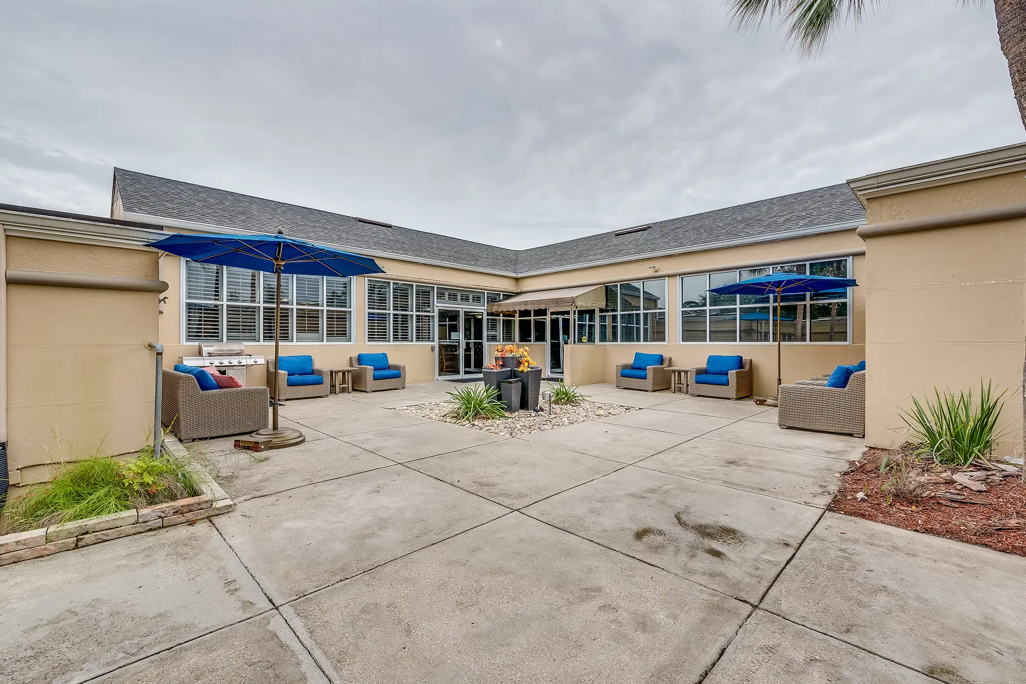 Outdoor seating area with blue umbrellas and couches