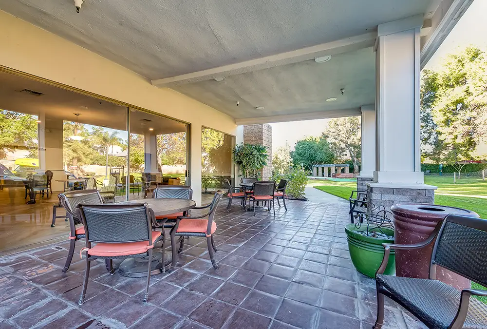 Outdoor patio area with seating and greenery