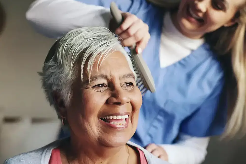 Resident getting hair done by a staff member