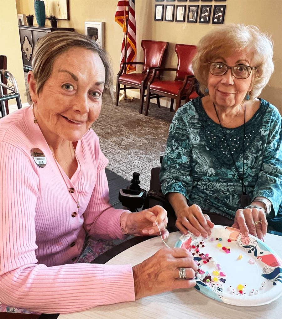 Two residents engaged in a creative activity.