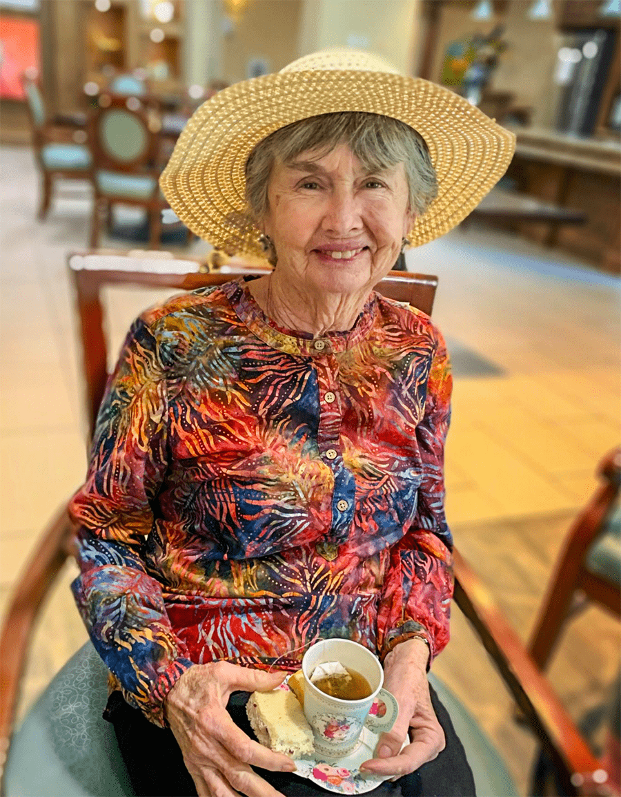 Resident enjoying tea in a colorful top