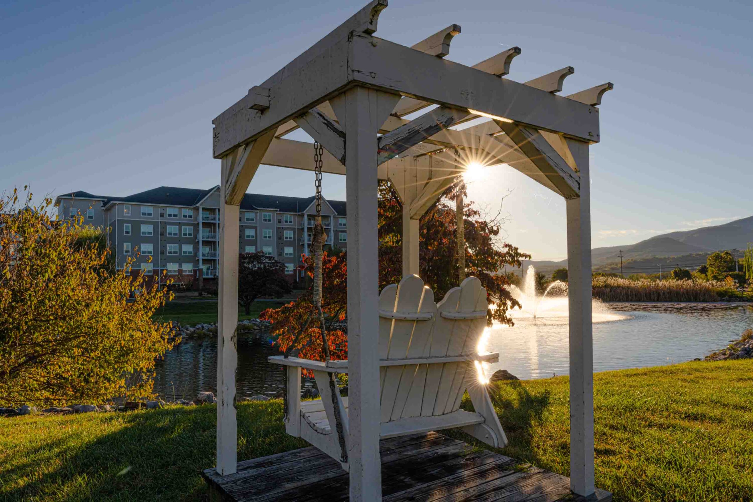 Outdoor gazebo with a scenic pond and sunset view