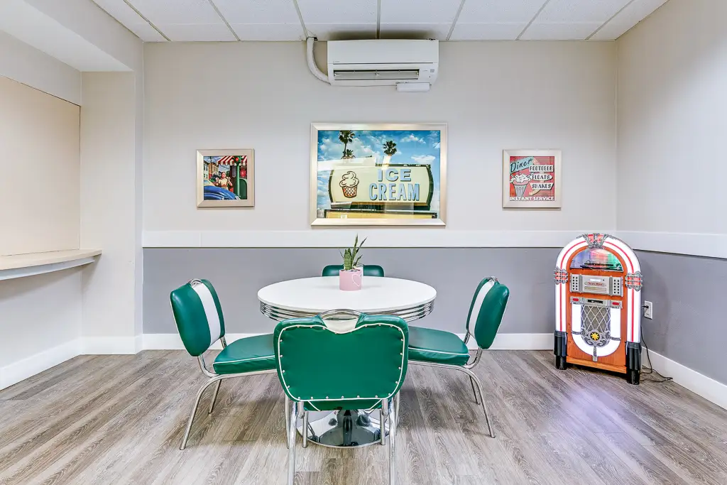 Colorful diner-style common area with table and jukebox