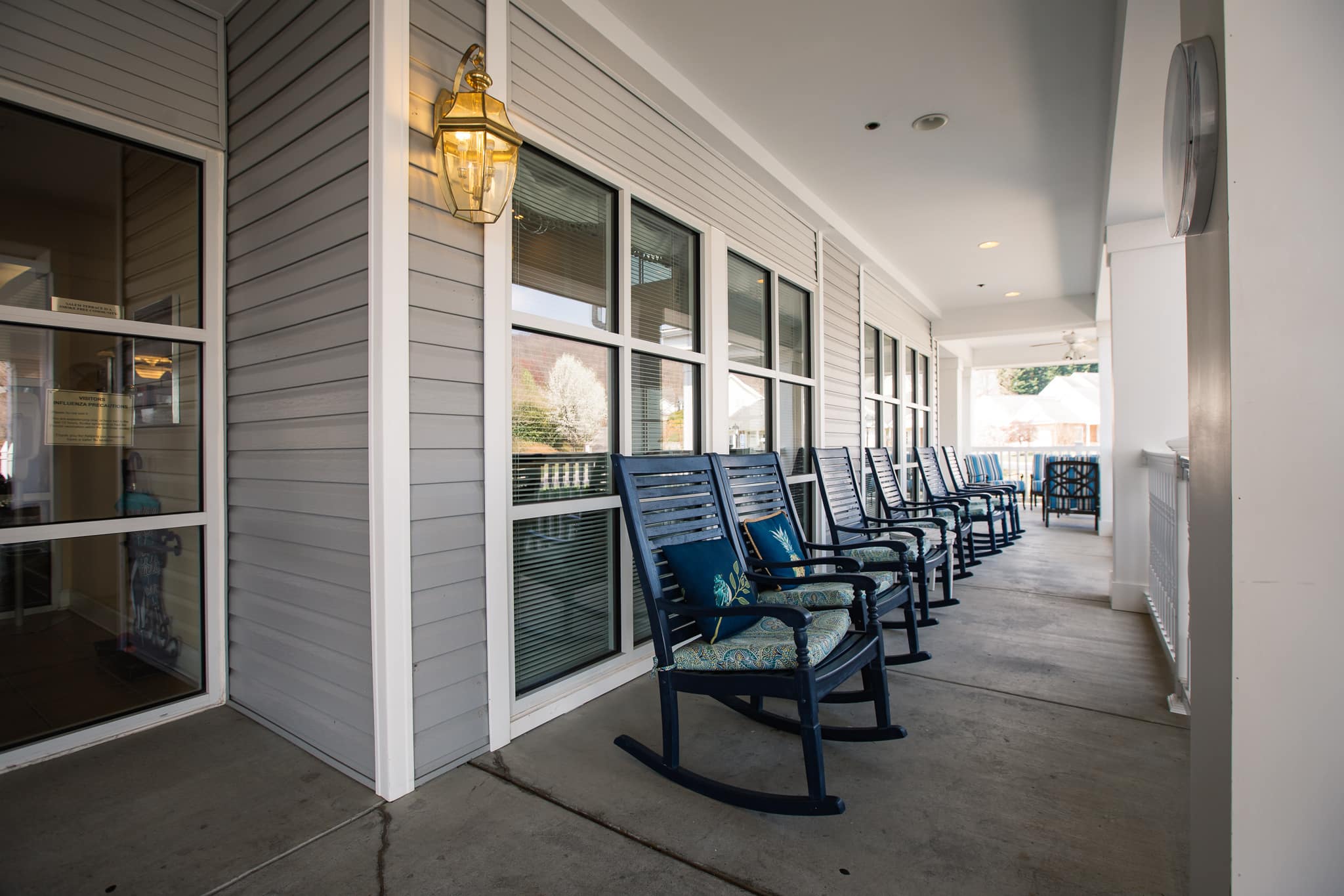 Rows of rocking chairs on a covered porch