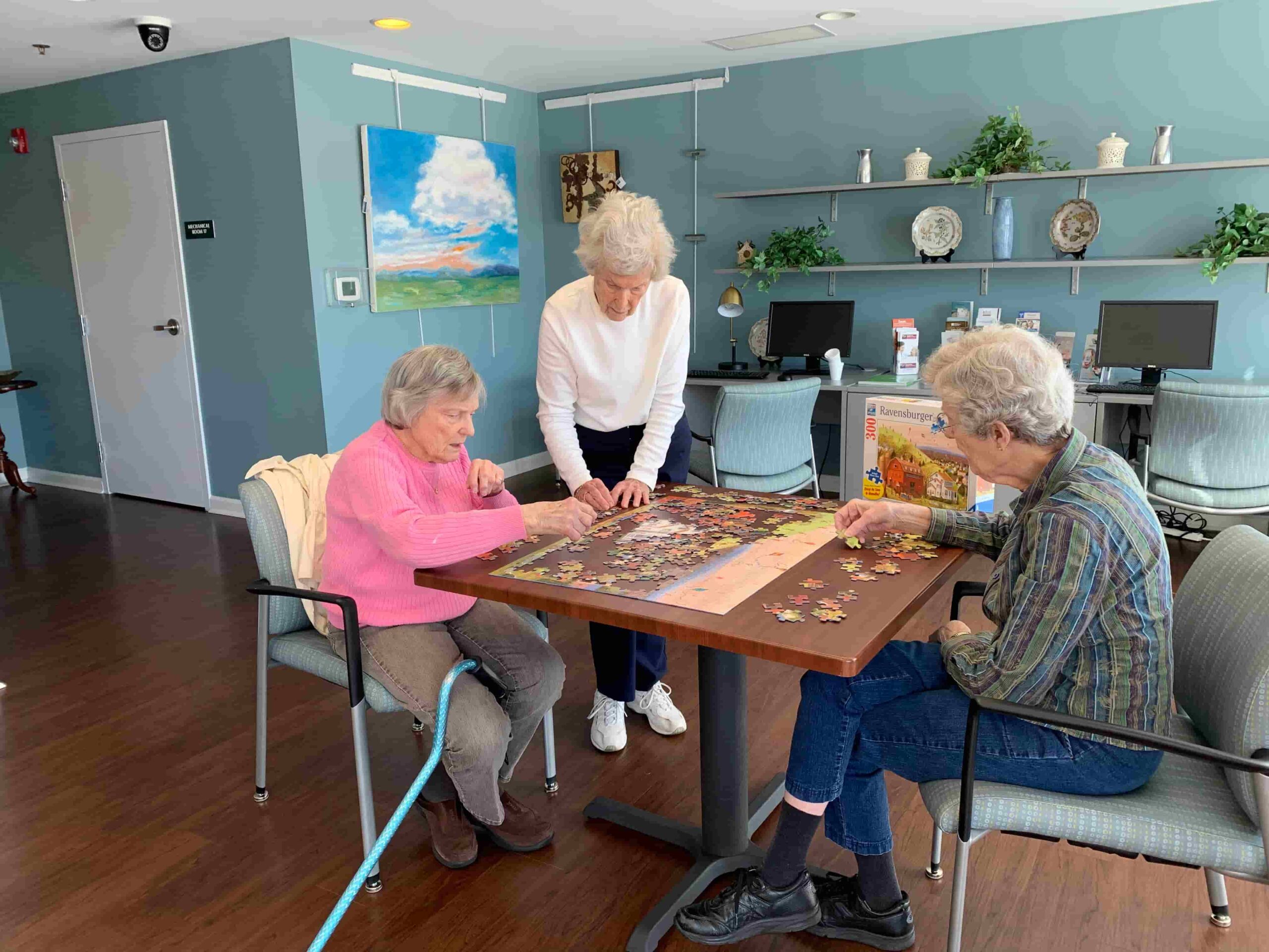 Residents working on a puzzle in a common area