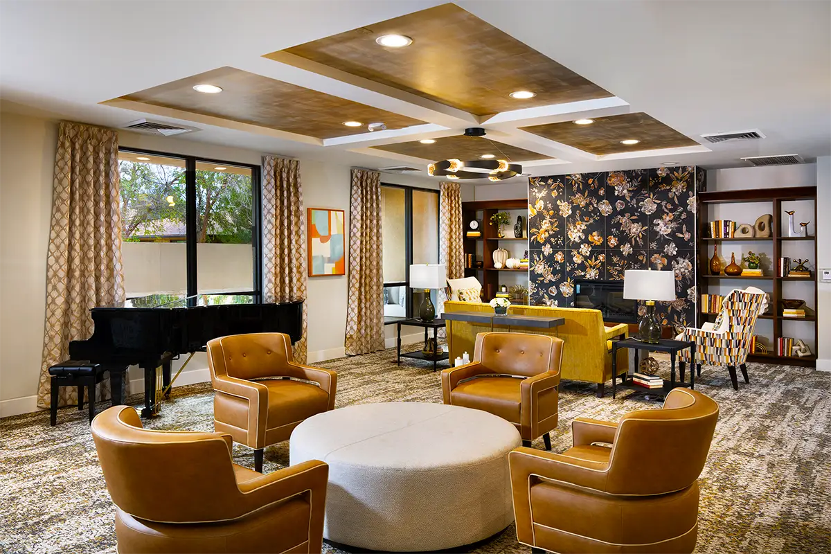 Bright common area with comfortable seating and bookshelves