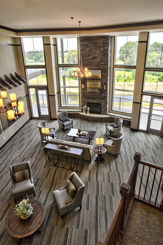 Bright and spacious common area with fireplace and seating