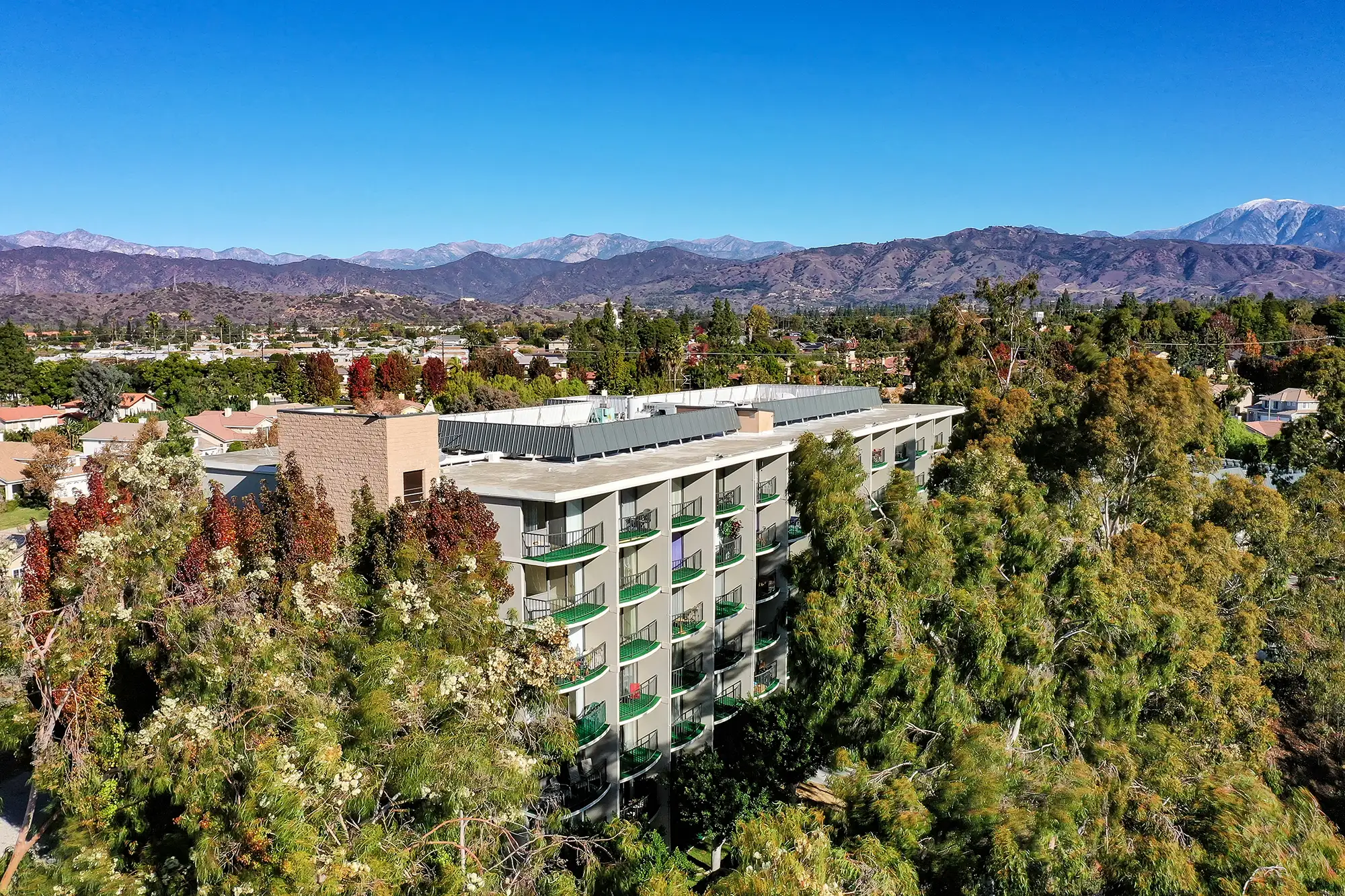 Aerial view of West Park Senior Living surrounded by trees and hills