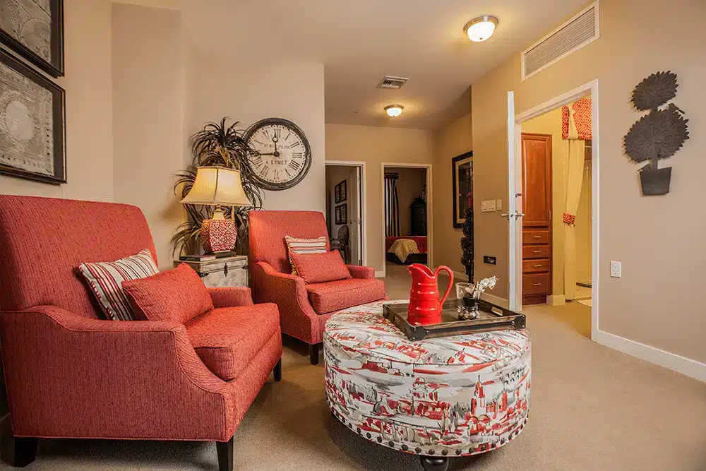 Cozy lounge area with red chairs and decorative table