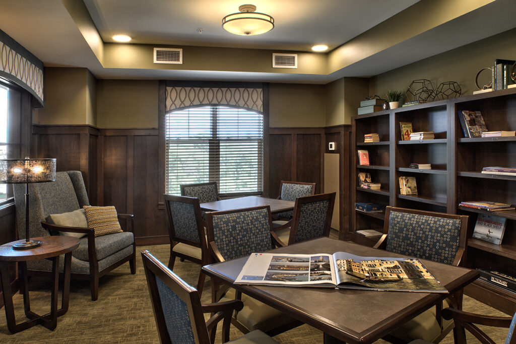 Cozy common area with tables and bookshelves