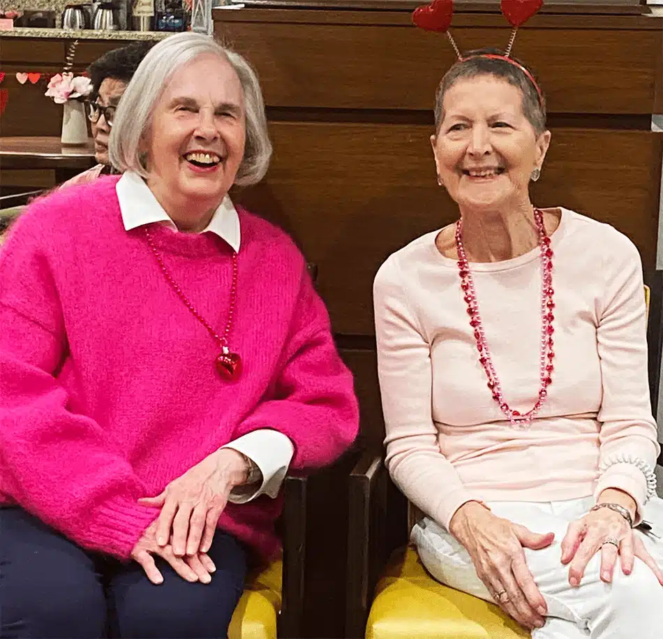 Two smiling residents enjoying a social gathering